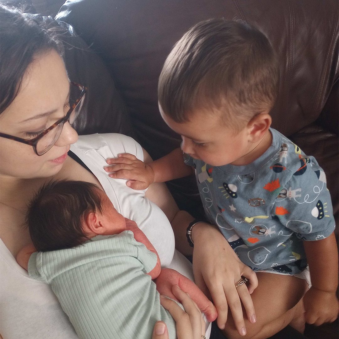 Adrianna C. holding her two children image