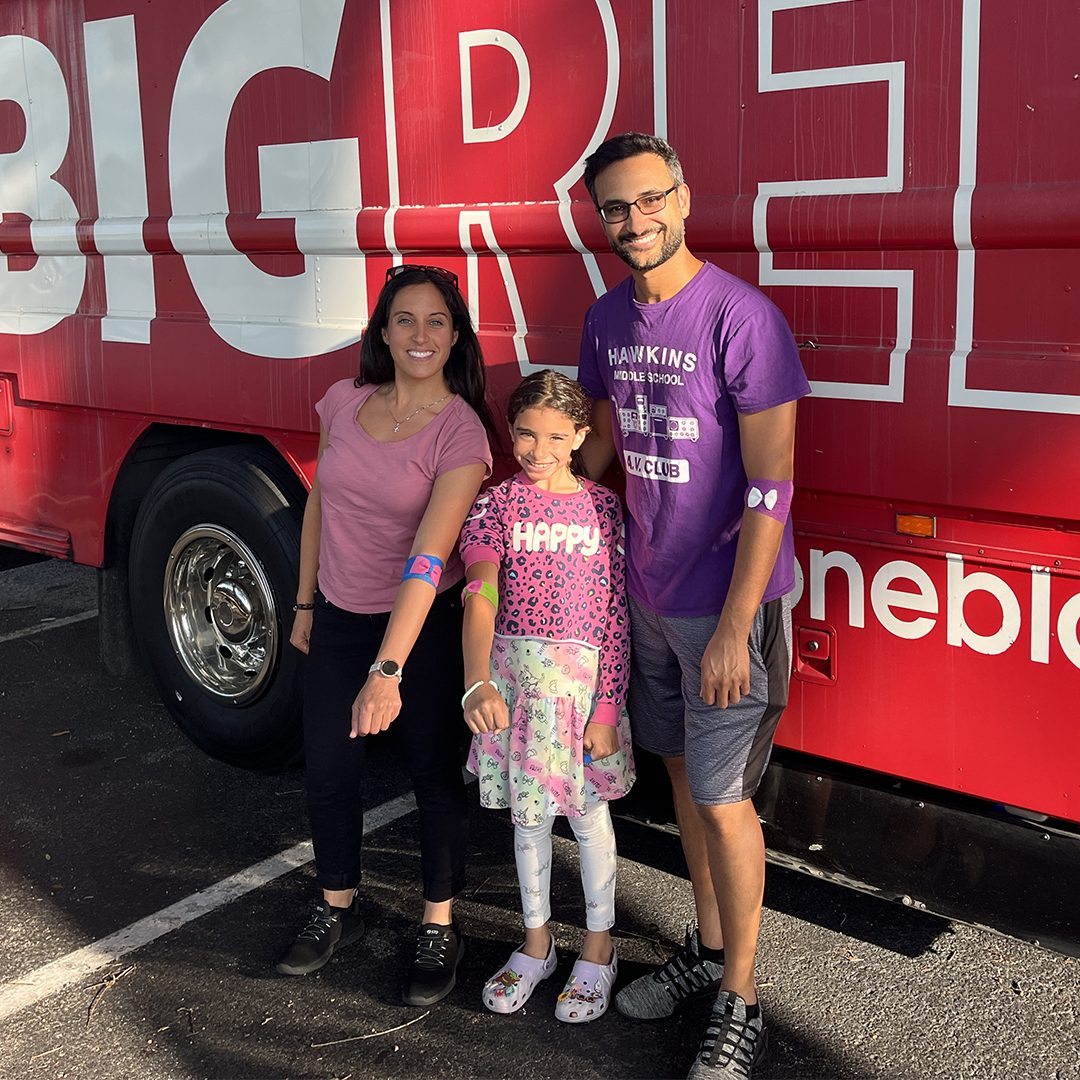 Digital Media Release Family in front of the Big Red Bus