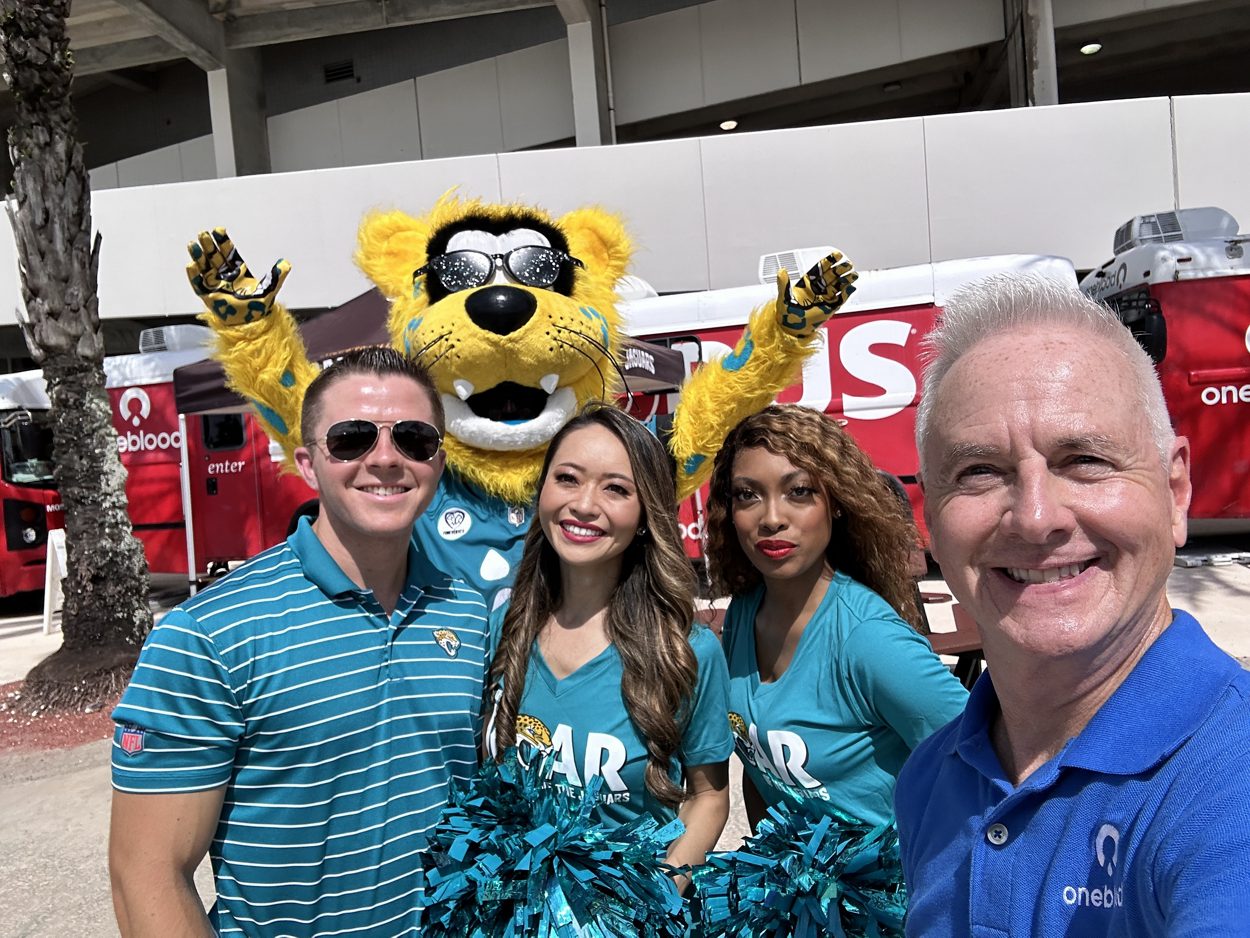Brian at the 2023 Jaguars Touchdown for Life Blood Drive with Mascot Jaxson de Ville and cheerleaders from the ROAR of the Jaguars