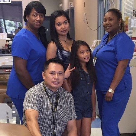 OneBlood donor, Carlo, and his daughters with OneBlood Phlebotomists