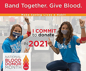 ‘Band Together. Give Blood.’ with the 2021 National Blood Donor Month in 2021. Two blood donors crouching, pointing to a sign that reads ‘I commit to donate in 2021’
