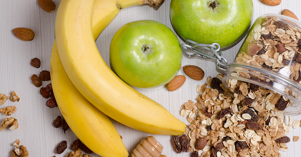 Bananas, apples, and granola, healthy low cholesterol snack alternatives