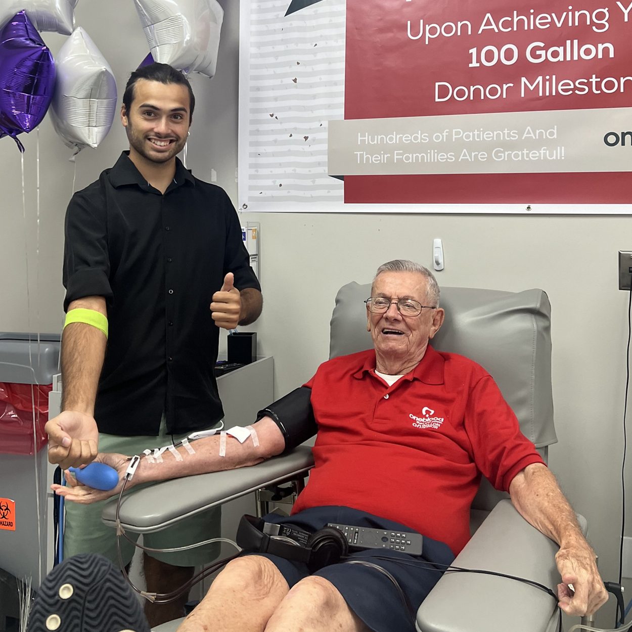 100-Gallon blood donor sitting donating platelets next to a first-time blood donor at a OneBlood Donor Center