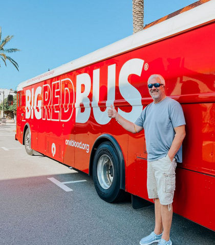 A donor outside of a Big Red Bus.