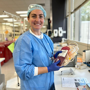 Leesa a Biologics assistant holding a unit ready to be process at a OneBlood lab