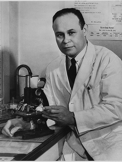 Dr. Charles Drew in front of a microscope