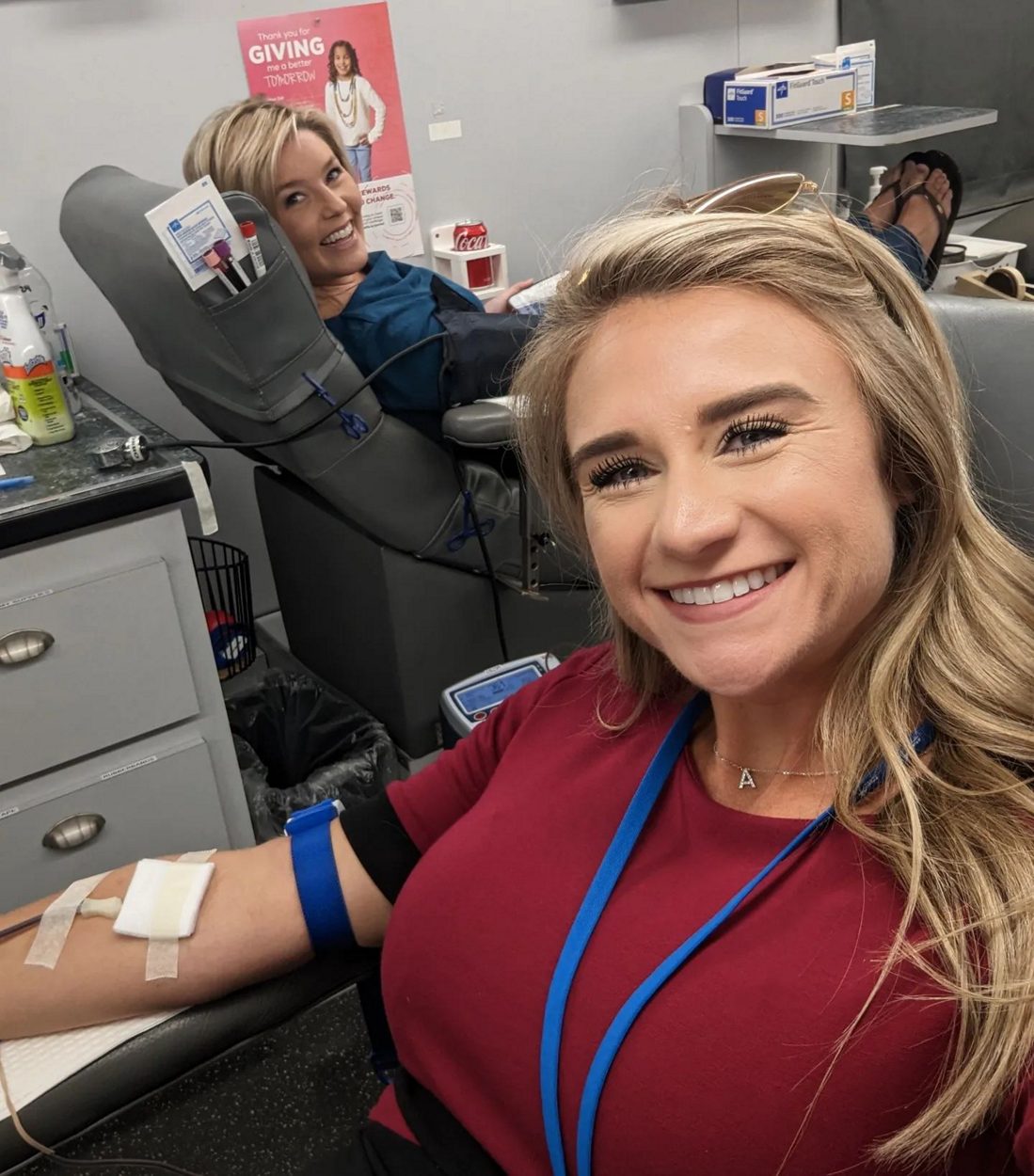 two happy women donating blood on the big red bus