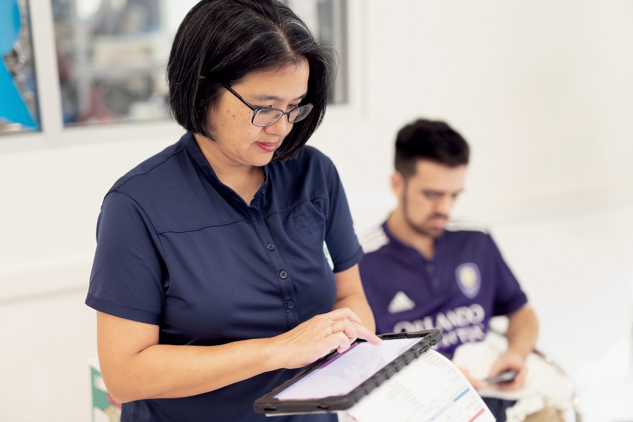 blood donor holding ipad and answering registreation questions