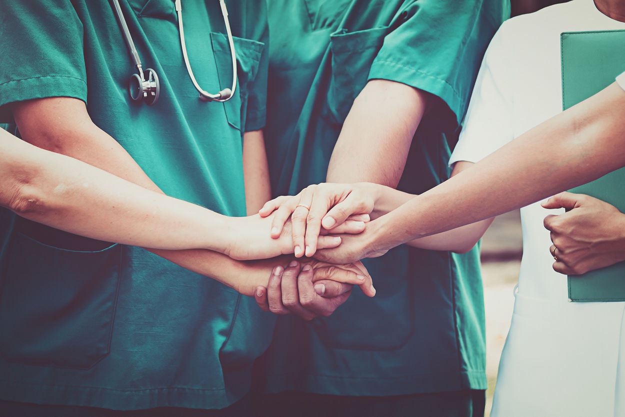 Doctors and nurses, hands together, teamwork
