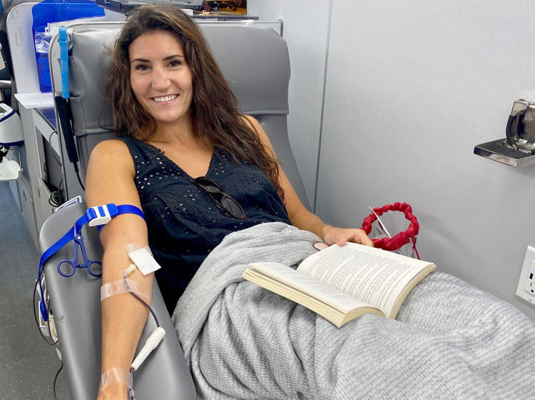 woman donating blood on the big red bus