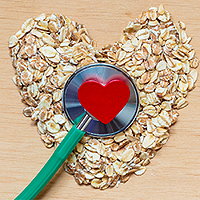 stethoscope with a red heart on the chest piece. The chest piece is laying in the middle of a heart made out of oats. 