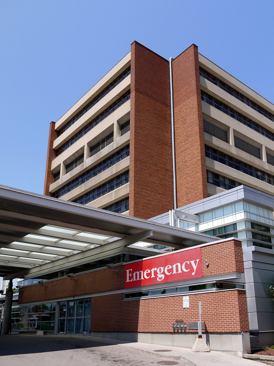 A modern hospital building, focussing on its emergency entrance.