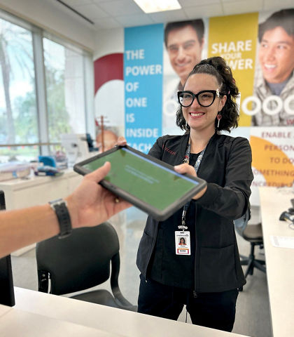 phlebotomist handing donor an ipad