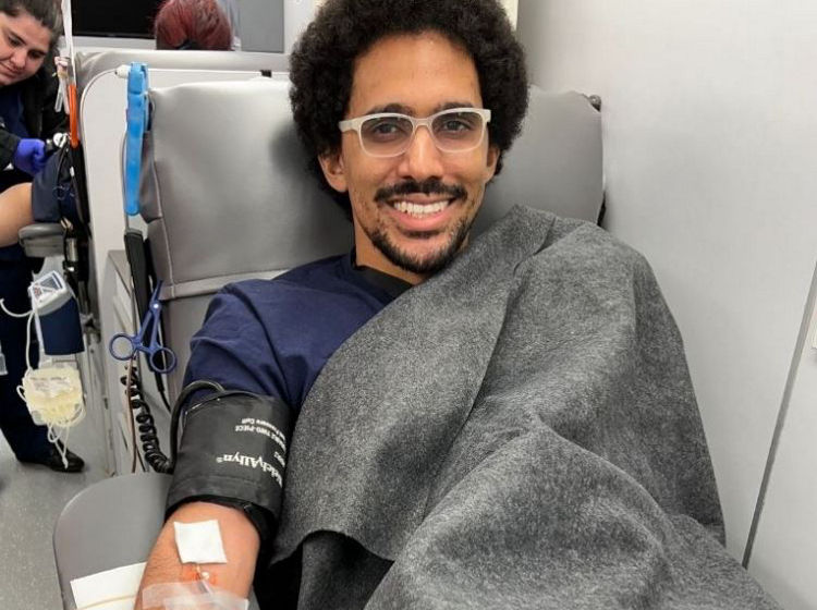 man donating blood on the big red bus