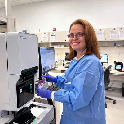 medical technologist woman standing, holding blood samples