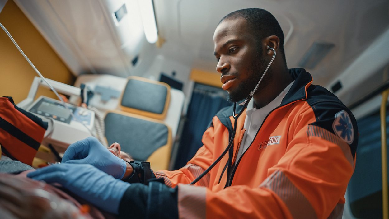 An EMT using a stethoscope 