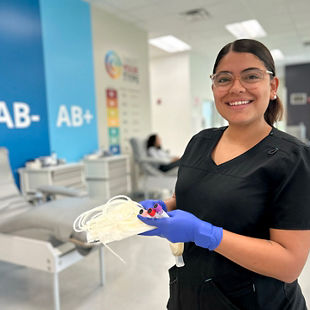 Phlebotmist holding a unit of blood at a donor center