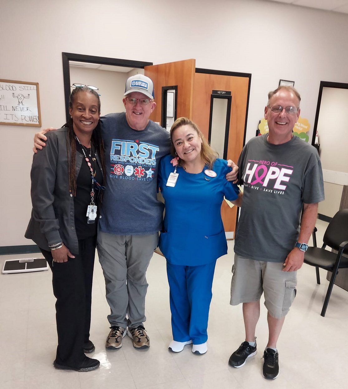 Platelet donor and whole blood donor smiling with two phlebotomist at oneblood donor center