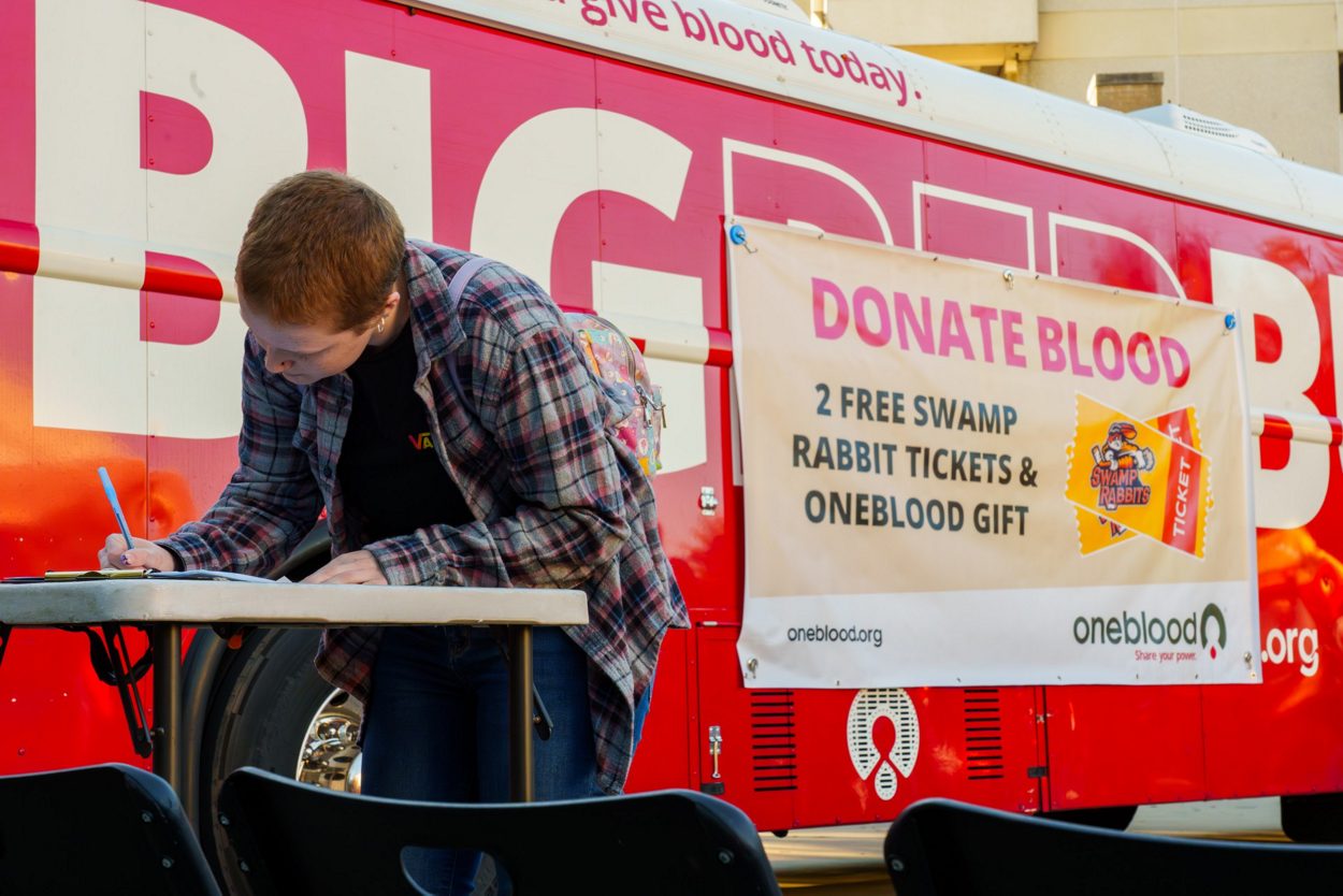 Blood donor outside a Greenville Swamp Rabbits Big Red Bus blood drive. 